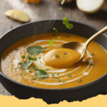 cremige butternut kuerbis suppe mit ingwer und kokosmilch - Eine Schüssel cremige Butternut Kürbis Suppe mit Ingwer und Kokosmilch, garniert mit frischem Koriander und Kürbiskernen.